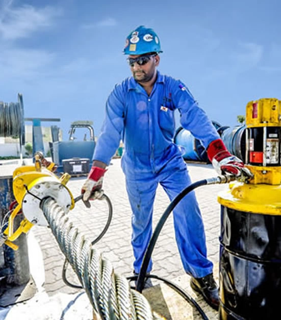 Technician Inspecting Wire Rope Outdoors